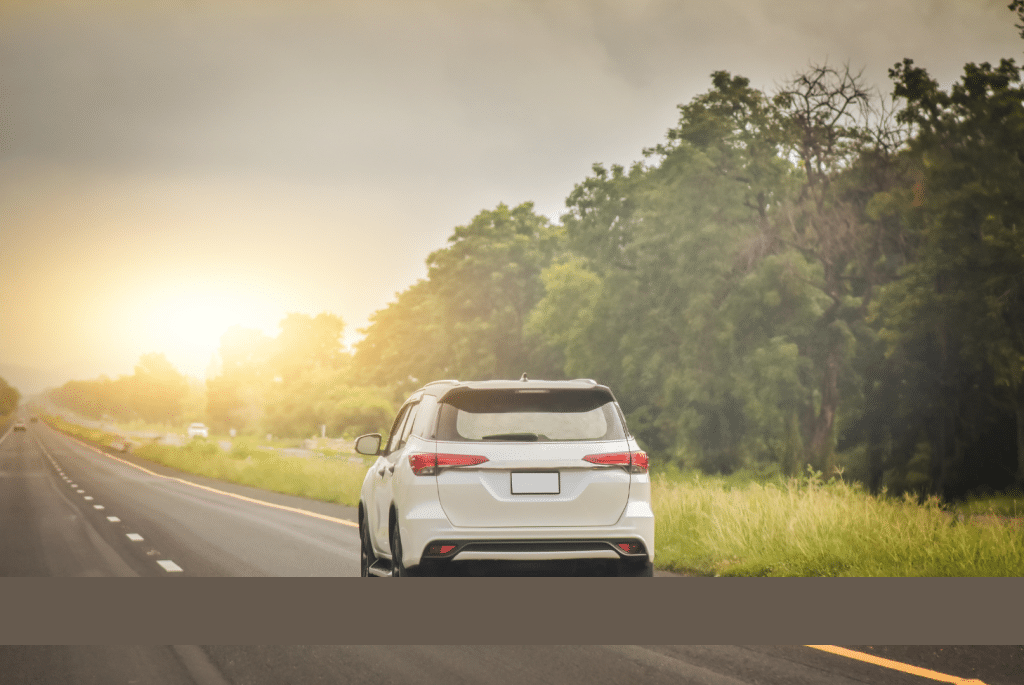 A sleek, modern car driving on an open road, illustrating the power and efficiency of a well-maintained engine