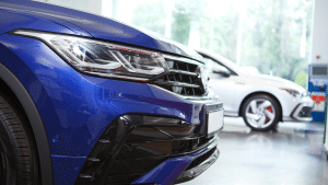 Front view of a blue affordable car in a showroom